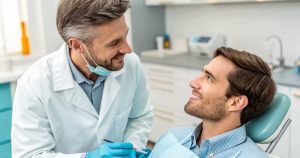 Dentist advising a patient on post-extraction care to avoid dry socket and support healing.