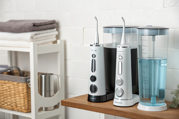 a photo of water flossers on a bathroom counter as one of the options of flossing techniques 