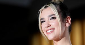 a photo of dua lipa after having dental veneers showing how long veneers last