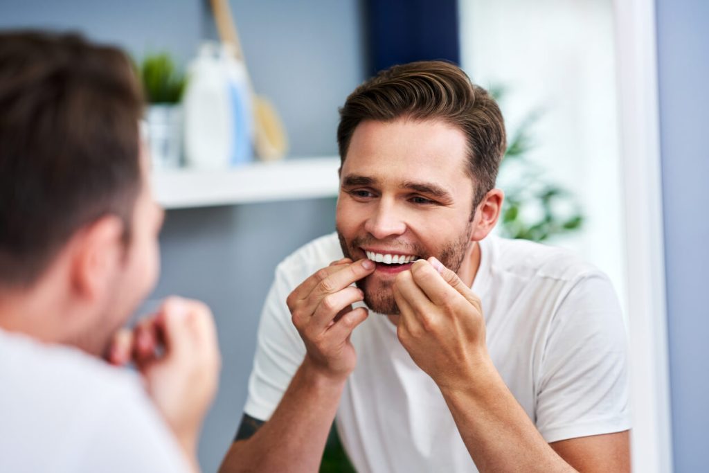 how to make your veneers last longer: flossing