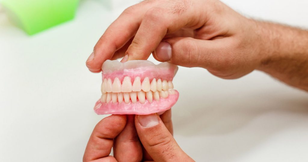 Artificial teeth of full mouth as an example showing denture sores