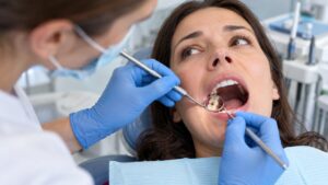 Dentist examining a patient with a chipped or damaged tooth.
