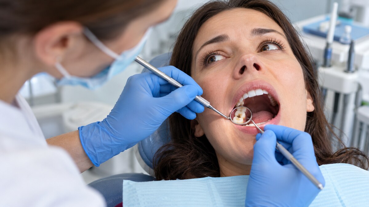 Dentist examining a patient with a chipped or damaged tooth.
