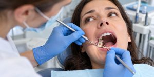 Dentist examining a patient with a chipped or damaged tooth.